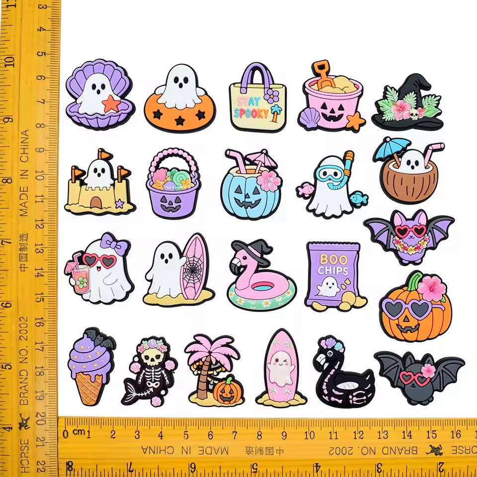 Assorted cartoon beach and Halloween PVC shoe charms with size reference