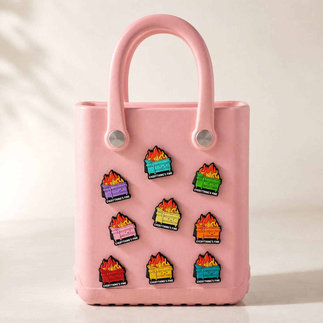 Premium hero image for custom rubber bag charms on a soft pink tote bag