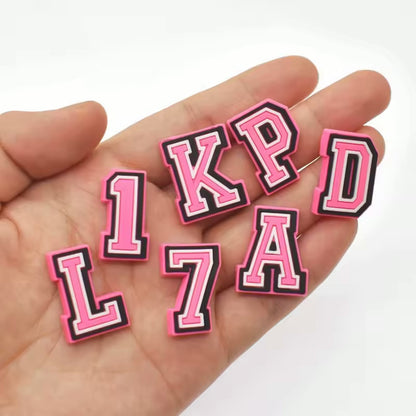 Pink PVC letter shoe charms close-up